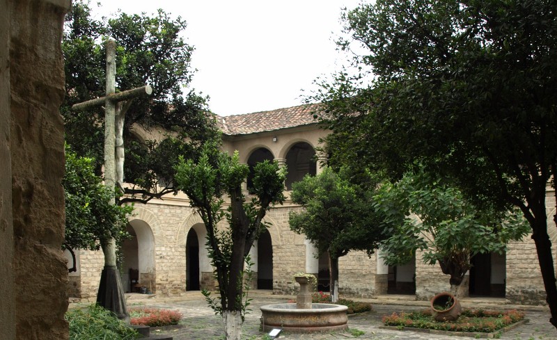 Courtyard with a crucifix and clay pot